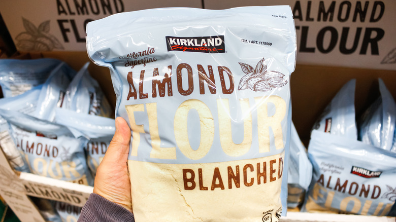 Hand holding bag of almond flour