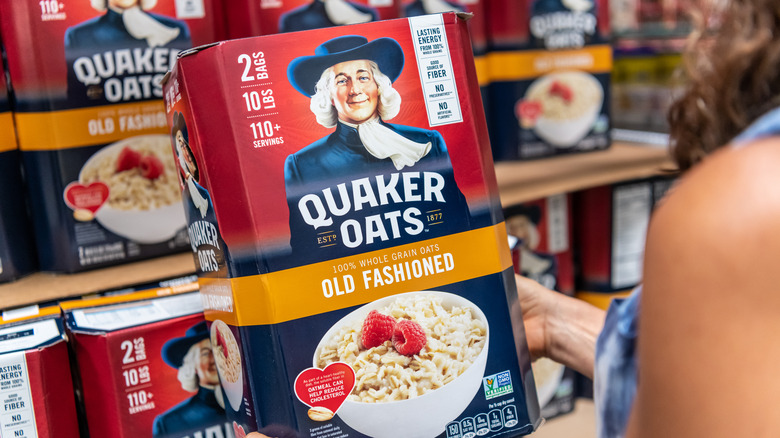 Woman holding box of Quaker Oatmeal