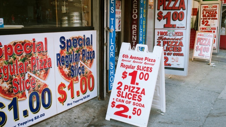 Dollar pizza signs outside shopfront
