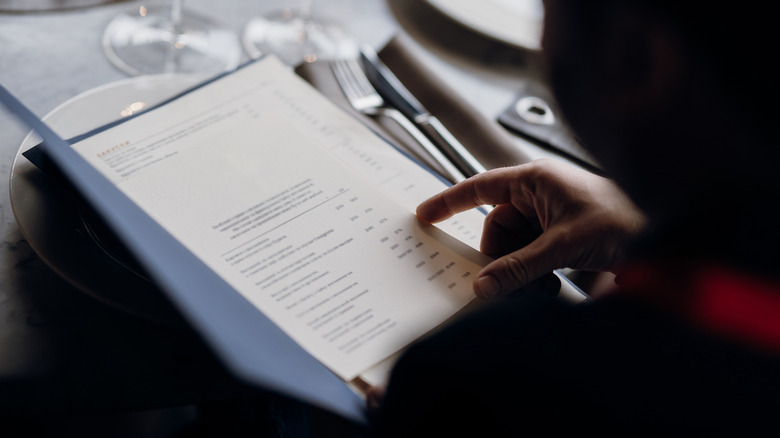 person reading menu at restaurant