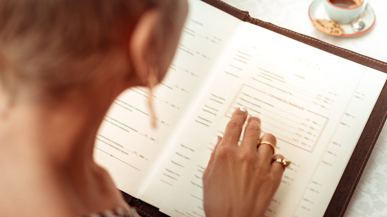 Person reading a menu