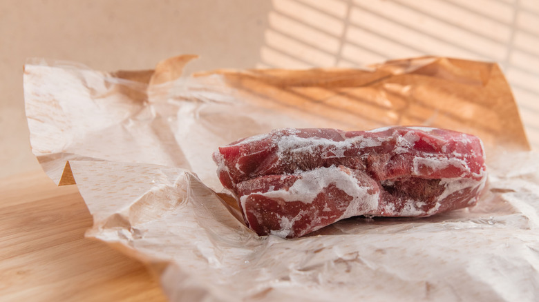 Frozen beef on brown paper