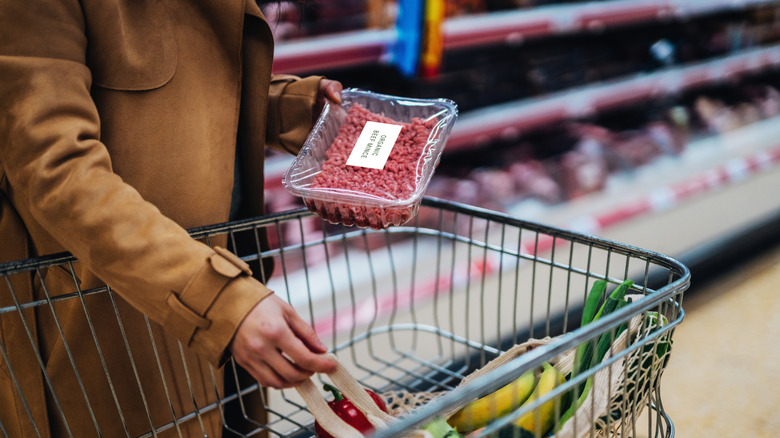 Person holding package of beef mince