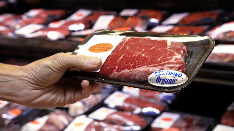 Man holding vacuum-packed steak