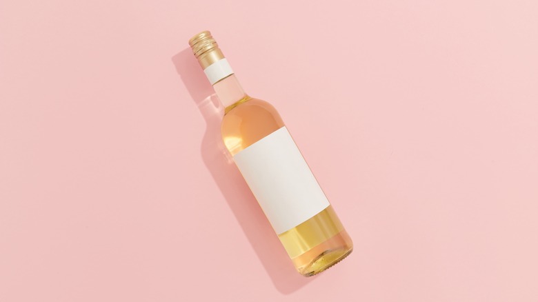 white wine on pink background