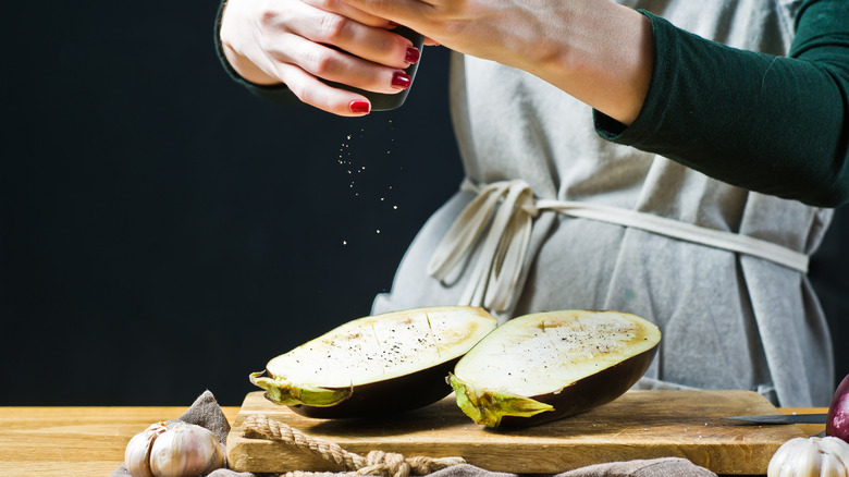 Person salting eggplant