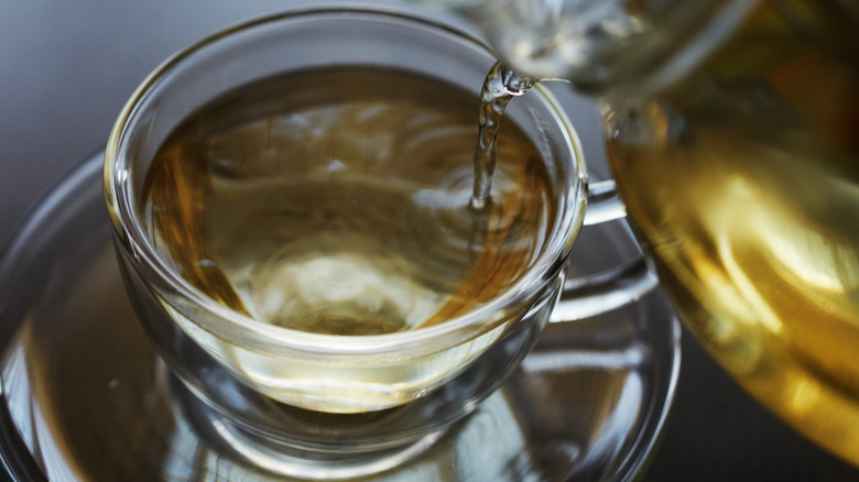 tea being poured into mug