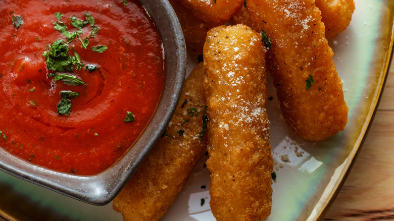 fried mozarella sticks, red sauce, green parsley