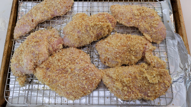 Raw chicken breasts on rack 