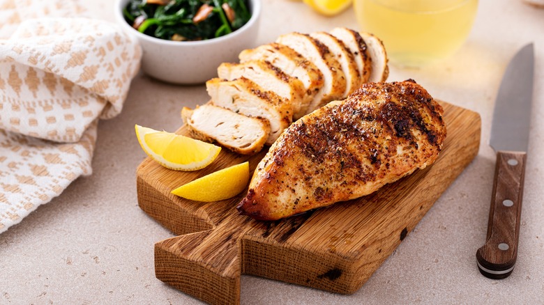 Cooked chicken breast on board