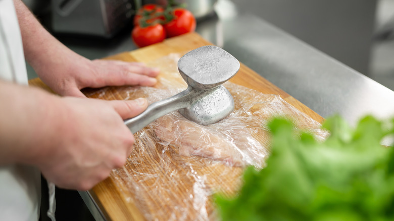 Tenderizing chicken breast with hammer