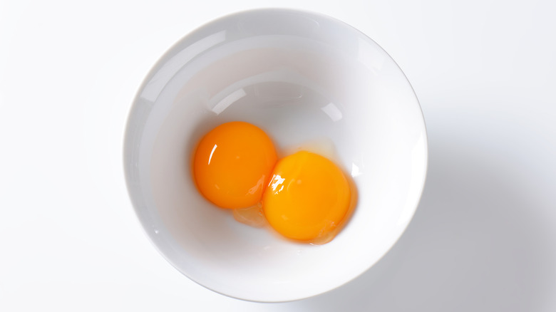 Two egg yolks in a bowl