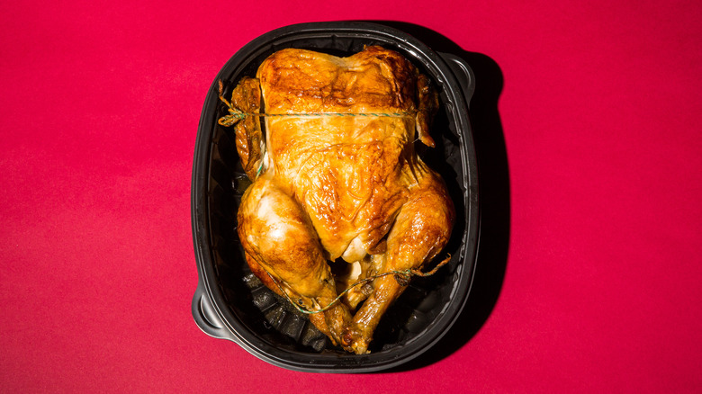 rotisserie chicken on red background