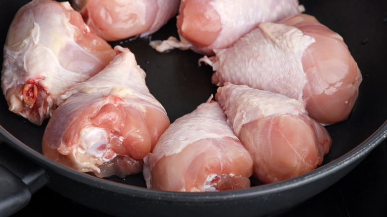 crowded chicken pieces in pan