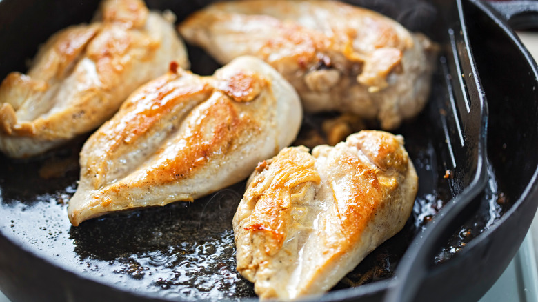 fried chicken breasts in pan