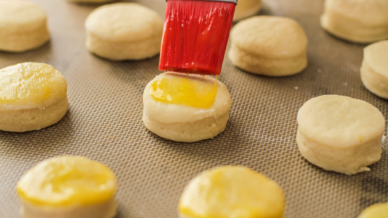 Brushing egg wash onto scones