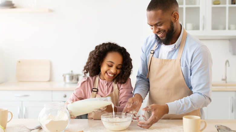 Father and daughter making dough