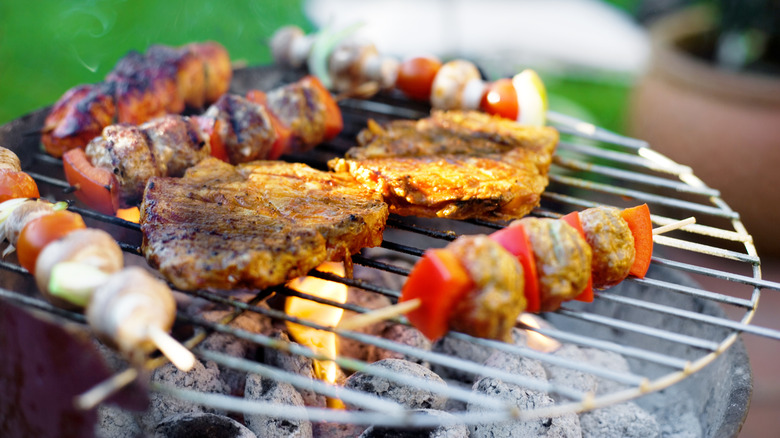 Foods cooking on charcoal grill