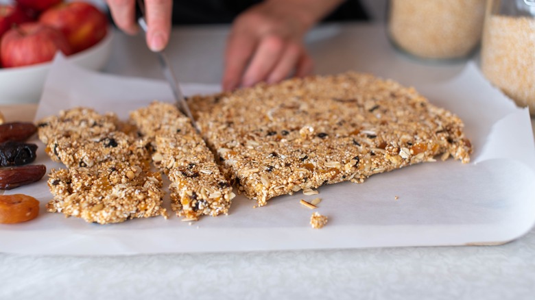 Person cutting granola bars