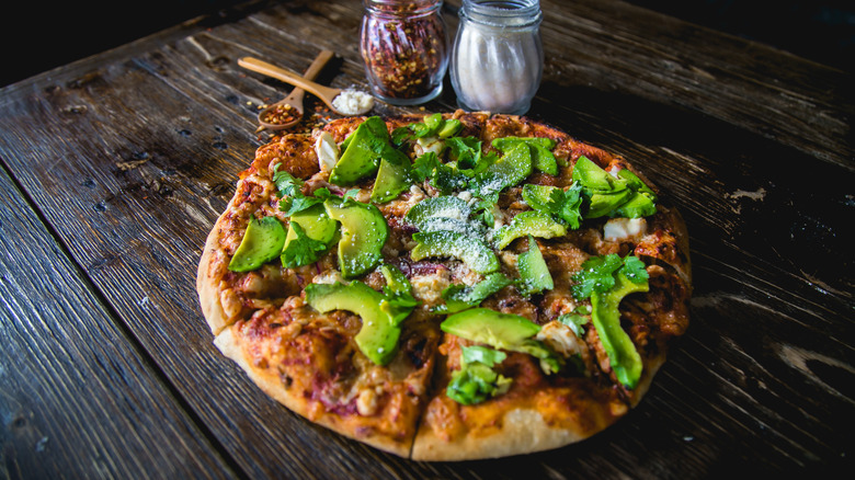 Wood oven pizza topped with avocado