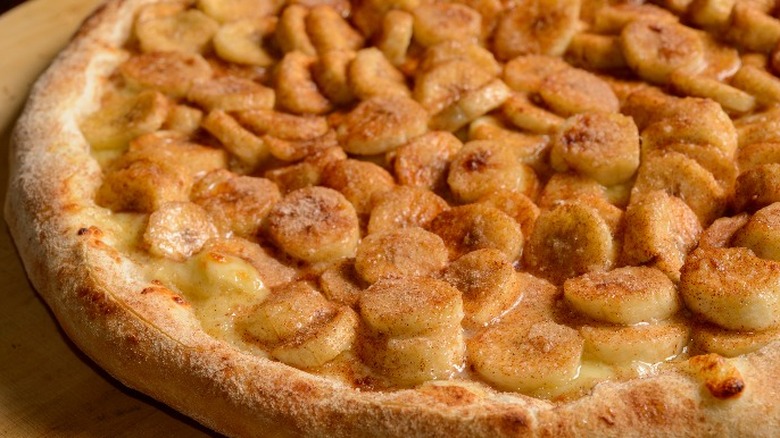 banana pizza with cinnamon on wooden board