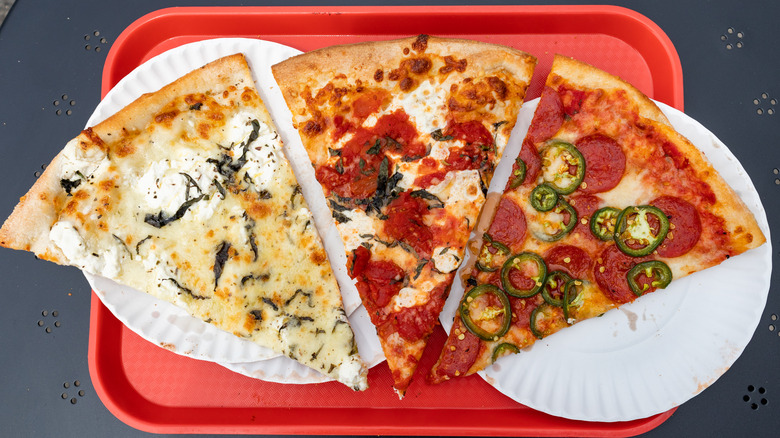 three new york style pizza slices on red tray