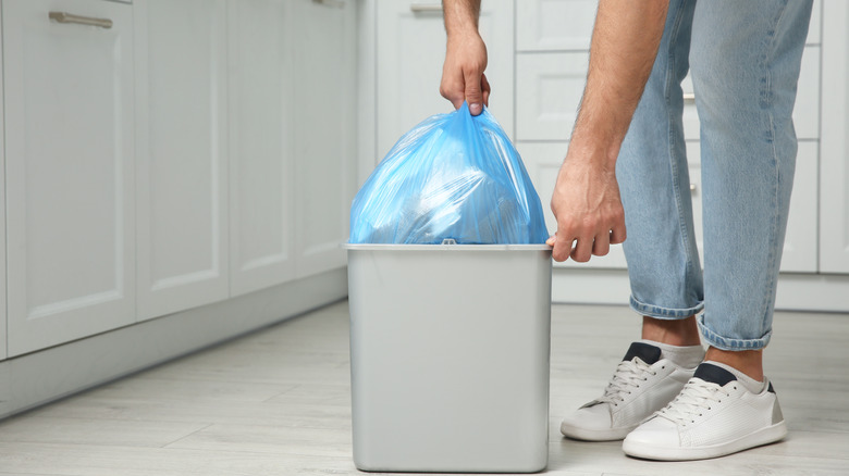 Emptying a small garbage bin