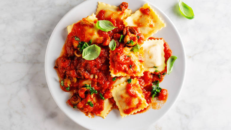 Ravioli with tomatoes on top 