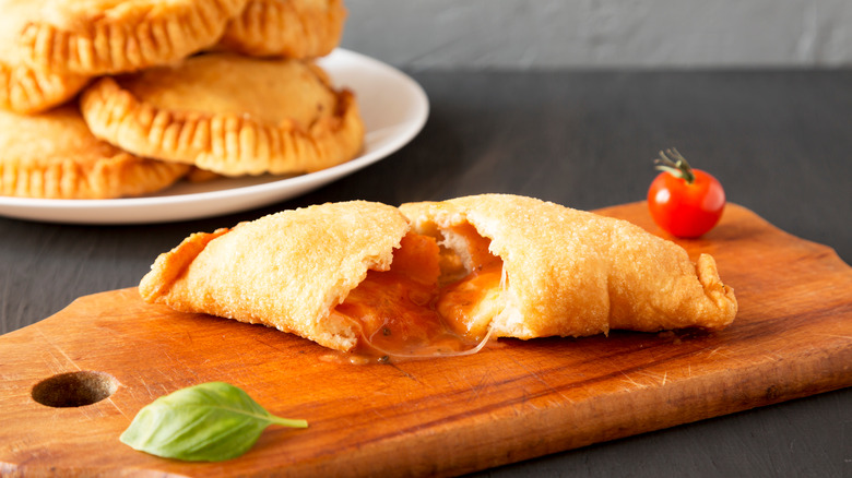 Baked calzone ripped in half