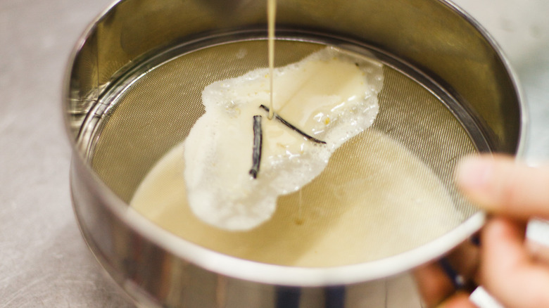 Straining custard with mesh sieve