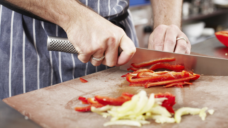 man slicing bell pepper