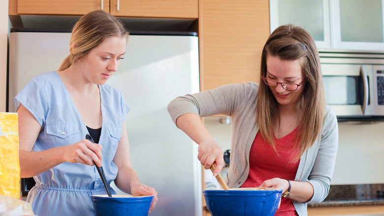 People mixing batter in bowls