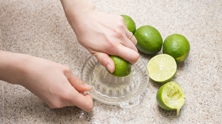 Person juicing fresh limes