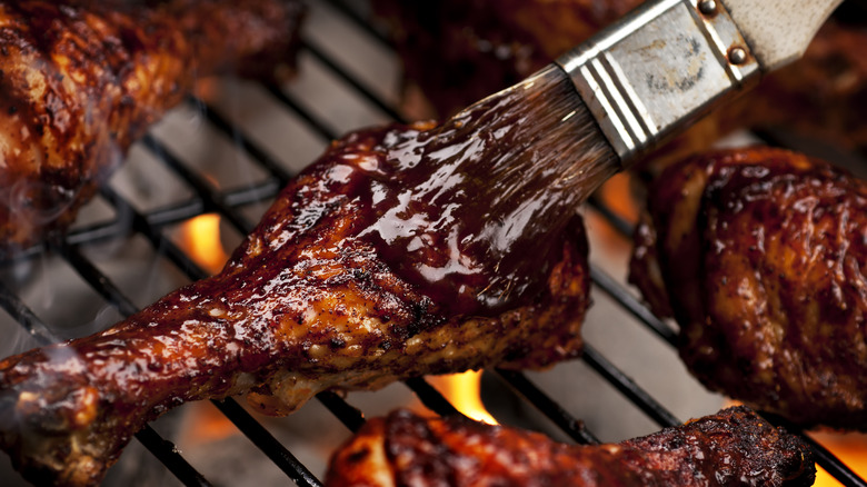 Barbecue sauce being applied to chicken