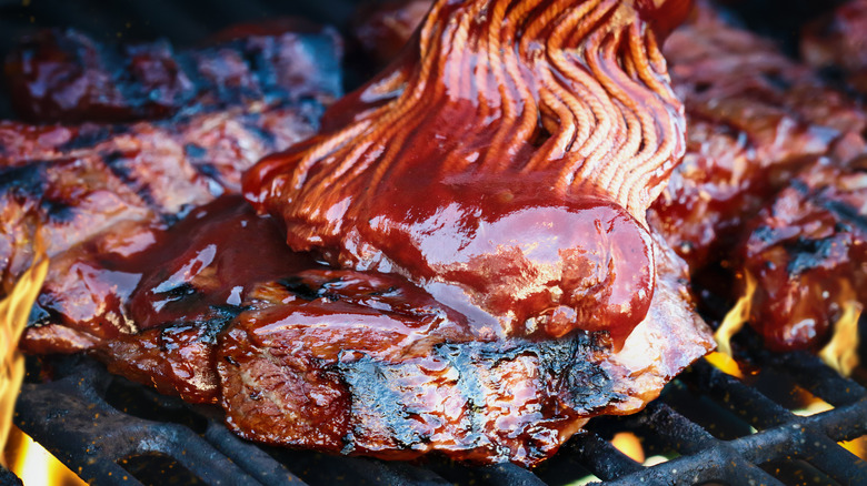 Mop sauce being applied to meat