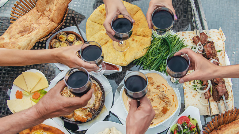 6 people with wine glasses cheersing