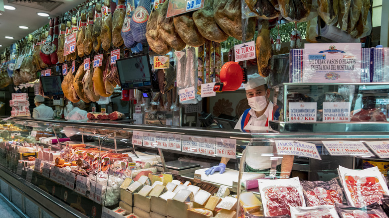 A butcher with selection of hams