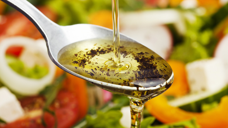 pouring salad dressing