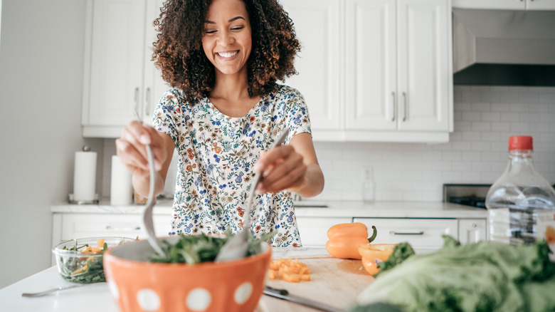 person mixing salad