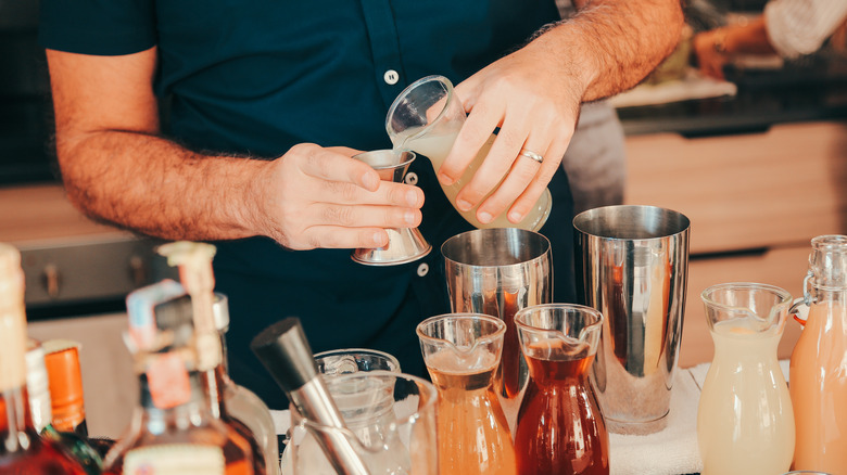 home bartender measuring drinks