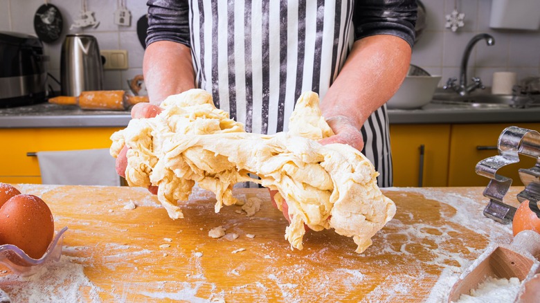 Person working with sticky dough