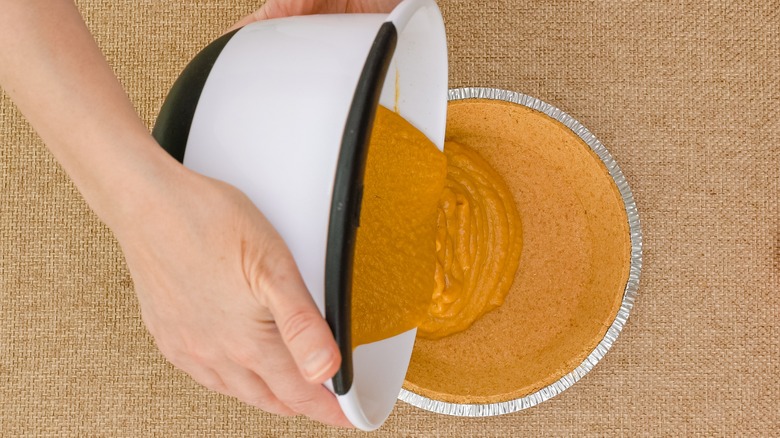 Pouring pie filling into crust