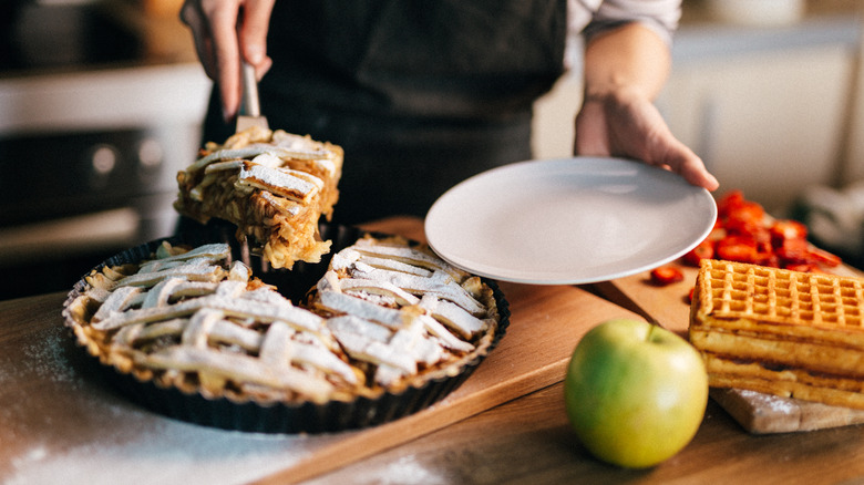 Person serving decorated pie