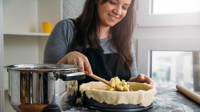 Woman filling pie shell