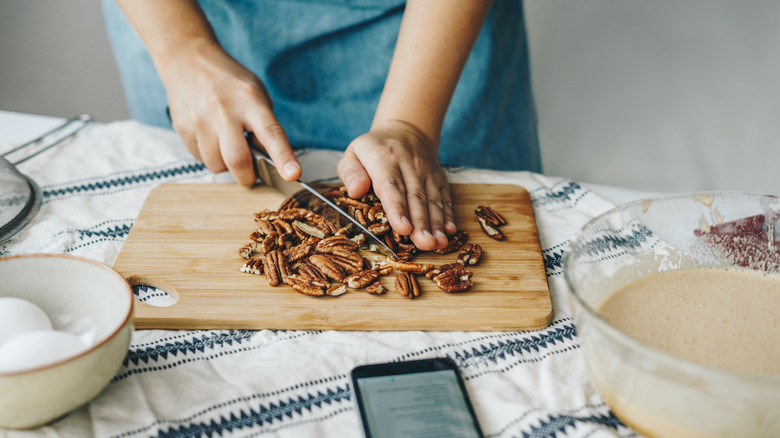 person chopping pecans