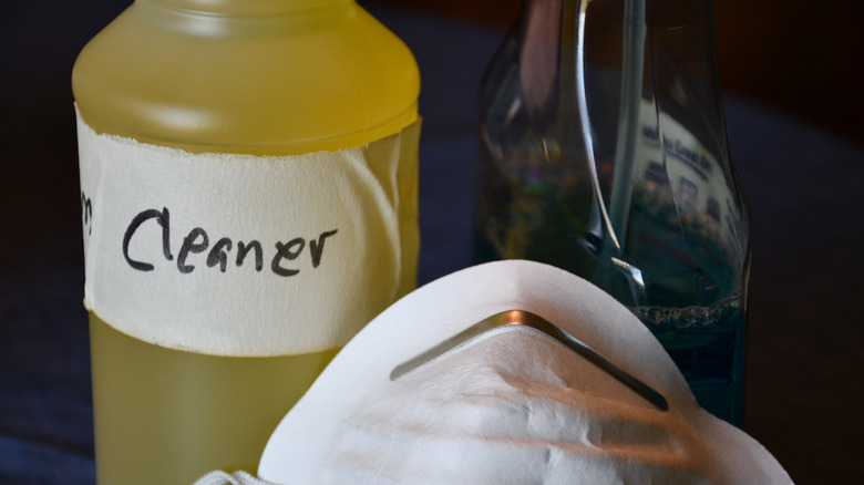 Bottle of cleaner and mask