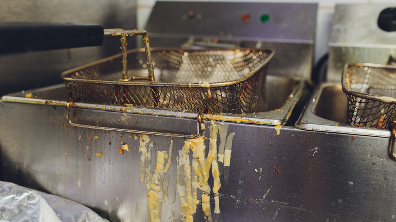 Commercial deep fryer with stains all over it