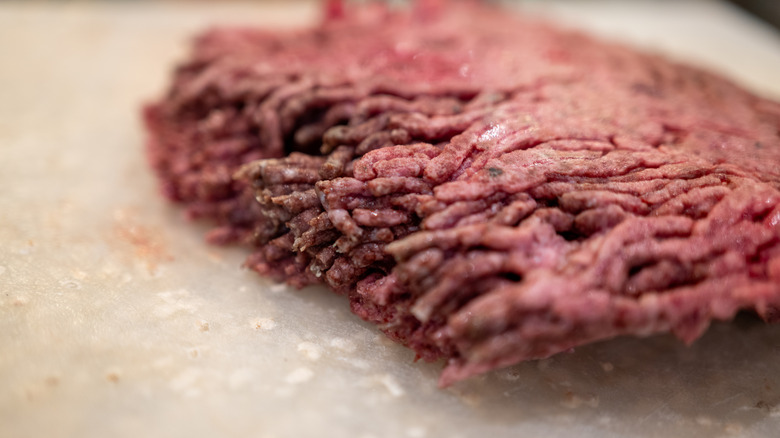 Rotting ground beef sitting on countertop