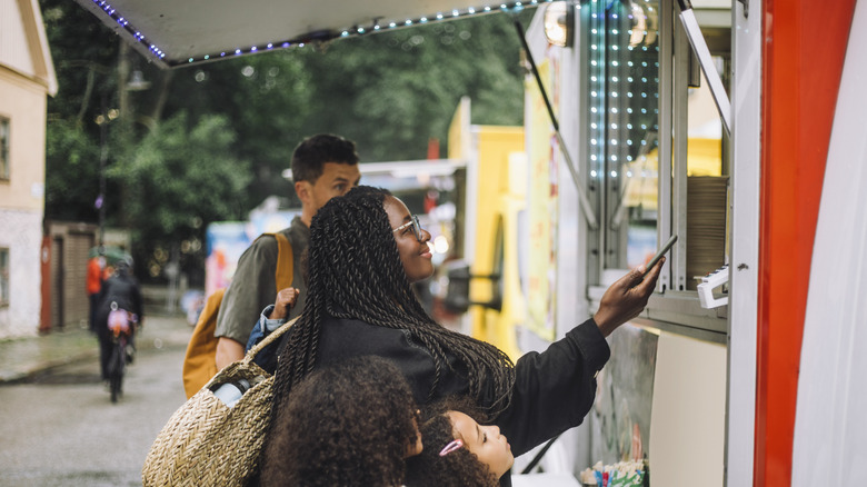 Woman buying food at concession stand