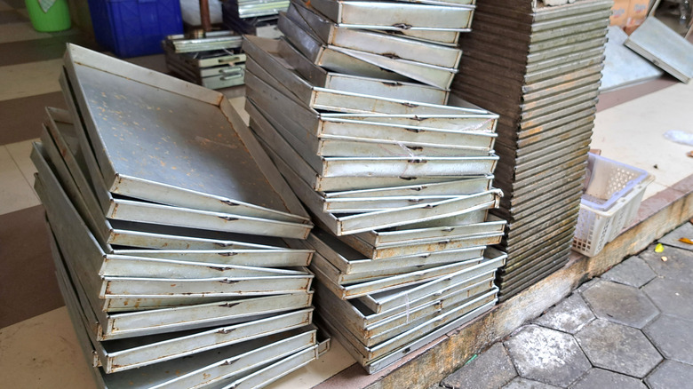 Stack of metal trays on the ground